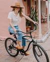 woman in caramel brown mule slip on shoes on a bicycle 