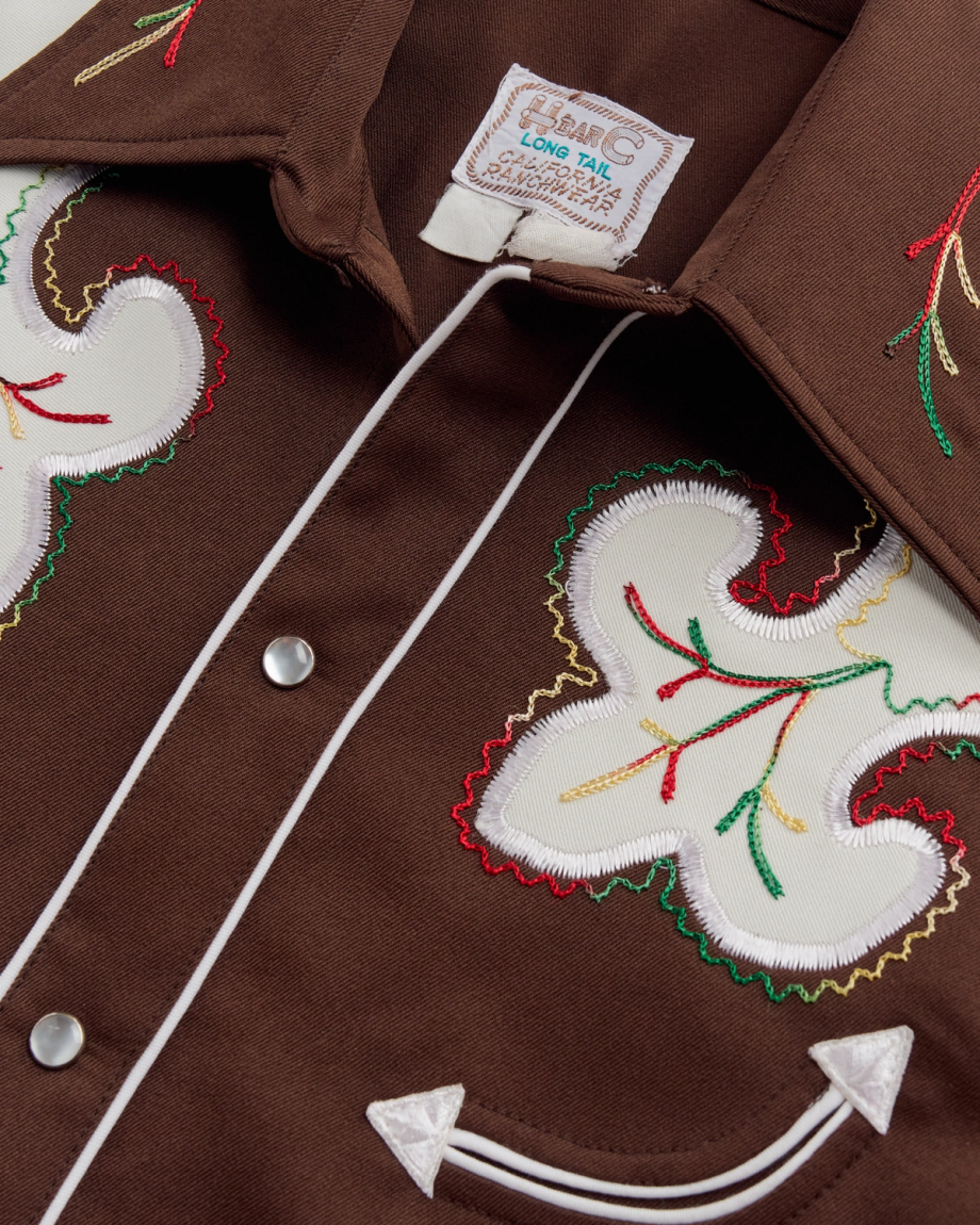 Closeup detail view of Tecovas x Cathy Hahn Men’s Vintage Smile Pocket Pearl Snap - Chocolate / Multi