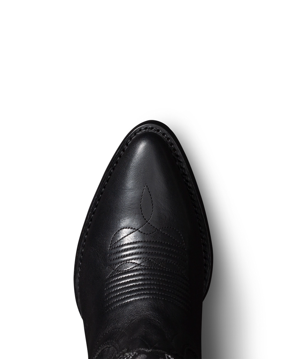 Top view of a black leather cowboy boot with decorative stitching.