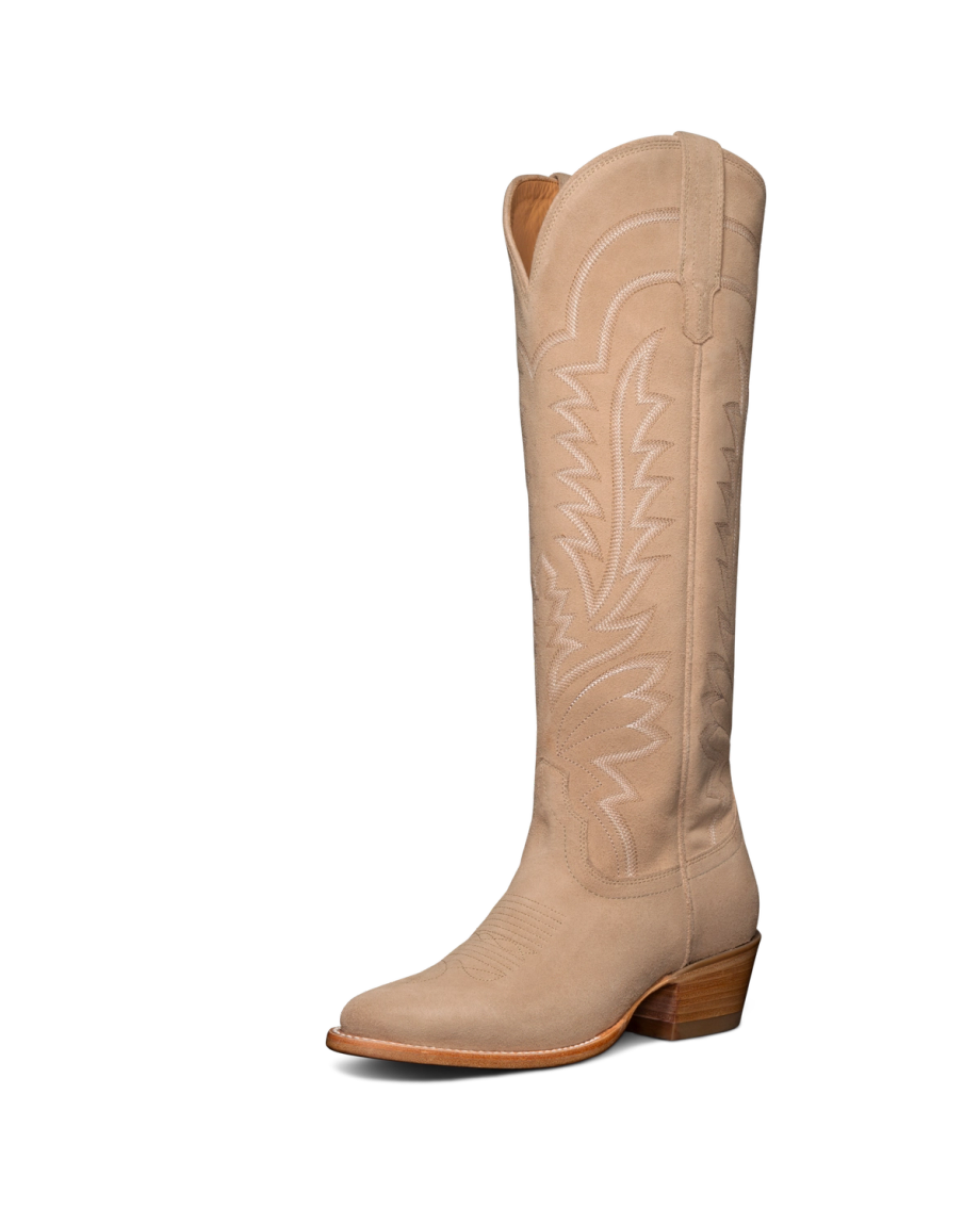 Tan cowboy boot with decorative stitching and a wooden heel, positioned against a black background.