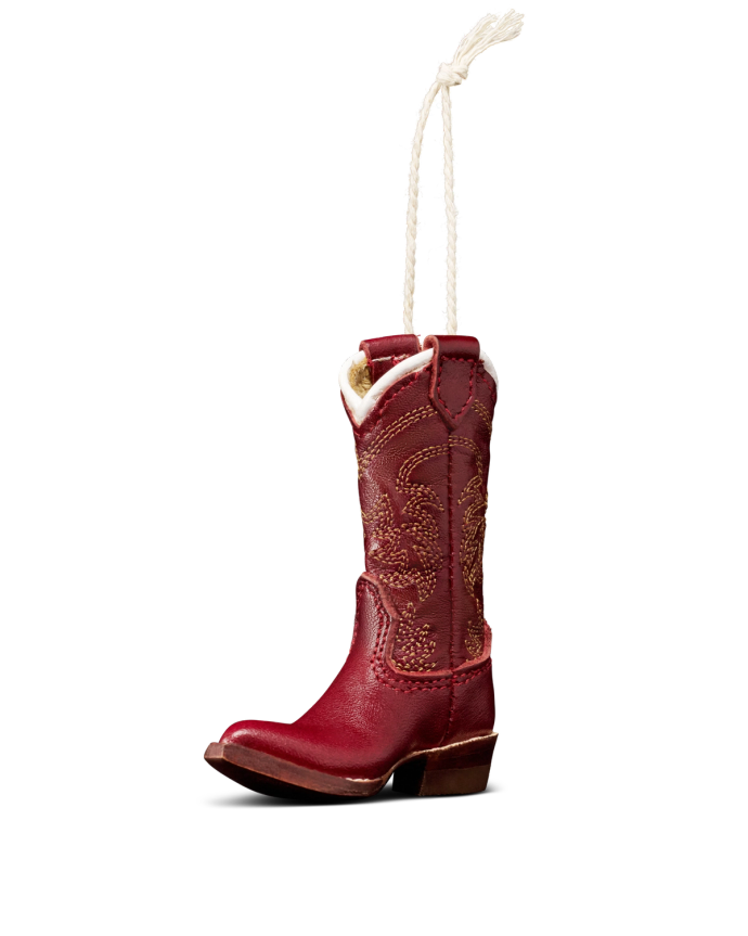 A red cowboy boot ornament with decorative stitching and a white hanging loop attached at the top.