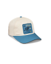 A cream-colored baseball cap with a blue brim and a blue patch reading "SEE TEXAS LONE STAR ESTABLISHED 1845" featuring an illustration of a bucking horse.