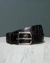 Front view of Men's midnight colored Crocodile Belt on a marble table