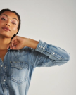 Closeup detail view of Women's Denim Pearl Snap - Light Wash