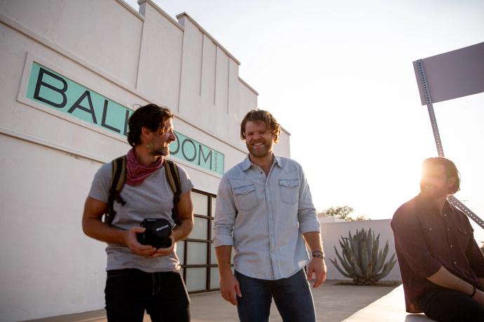 three men outside talking