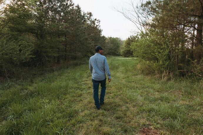 man in a field walking