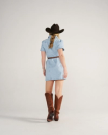 Closeup detail view of Women's Short Sleeve Mini Pearl Snap Dress - Light Wash