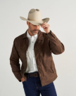 Man wearing the waxed canvas trucker jacket and a cowboy hat