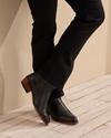 woman wearing the paige midnight black cowgirl booties 