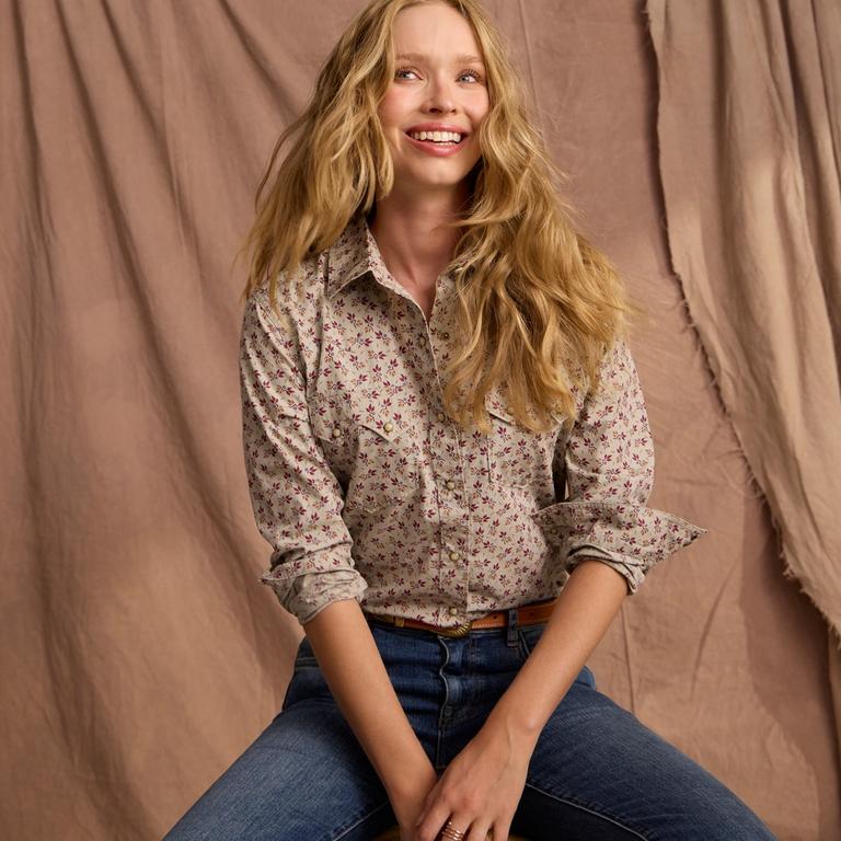 woman, jeans smiling in a studio