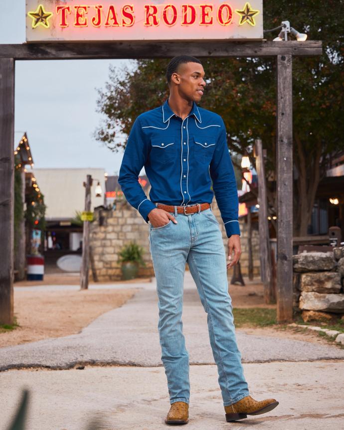 Man in a blue button down shirt and jeans