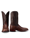 Two brown cowboy boots with intricate patterns and a textured, scaly surface. One boot is upright while the other is angled to display the design.