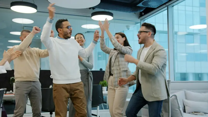 Team celebrating and having fun together in the workplace