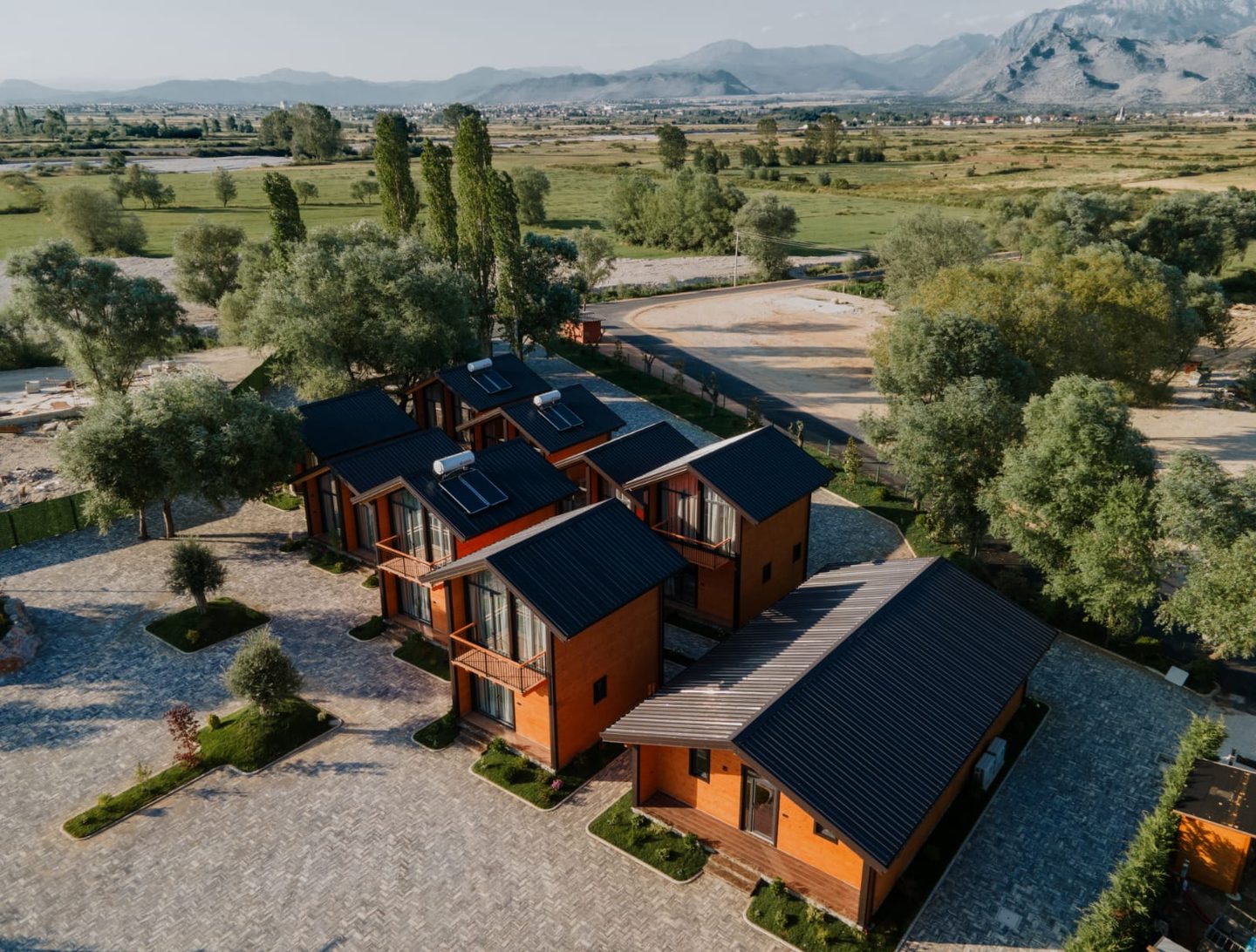 Aerial view of the timber guest houses at Hysaj Agroturizëm