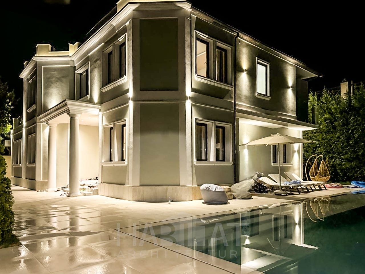 Night view of a classical villa beside its swimming pool
