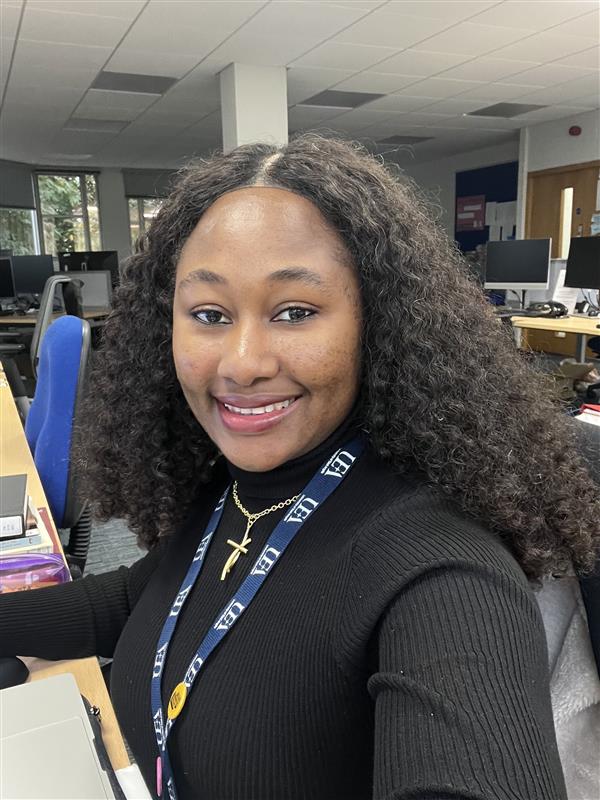 Headshot of Na'ankwat in an office space wearing a UEA lanyard