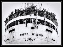 People aboard the crowded Empire Windrush Ship waving to onlookers
