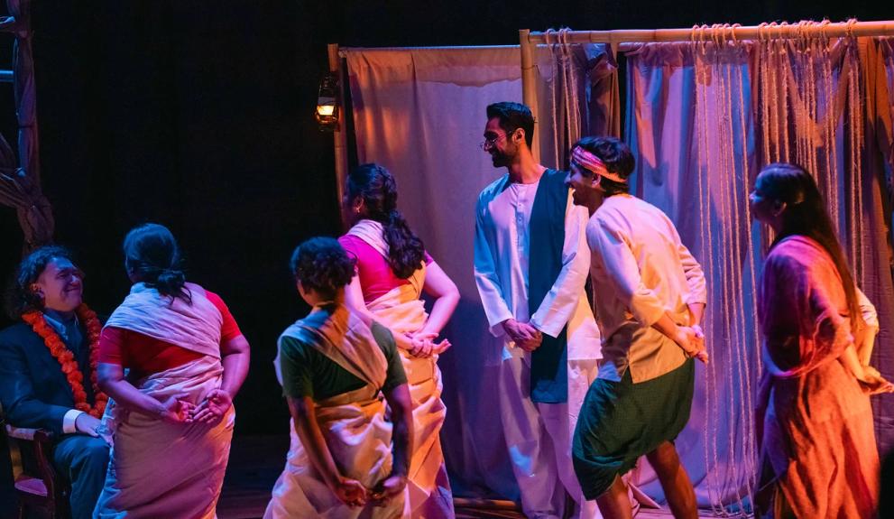 A production photo. Actors on stage. Workers greeting the new manager of the plantation.