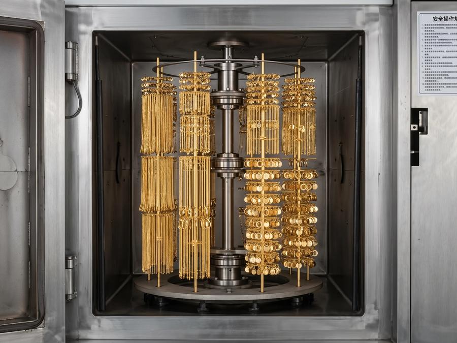Gold jewelry components arranged inside a PVD coating chamber