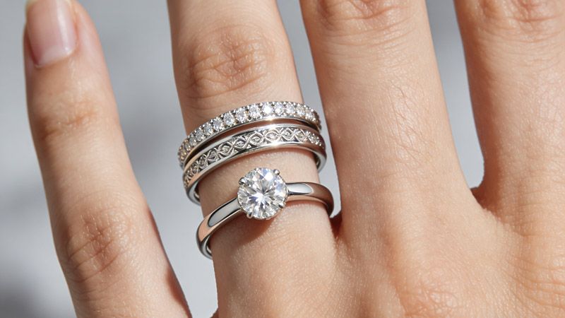 The engagement ring goes first, followed by wedding band.