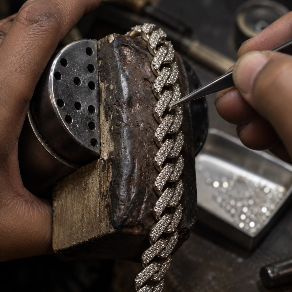 Stone setting work on an iced-out Cuban link chain during production