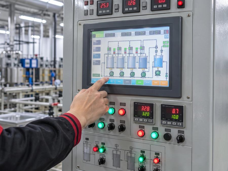 Technician configuring a controlled jewelry electroplating system
