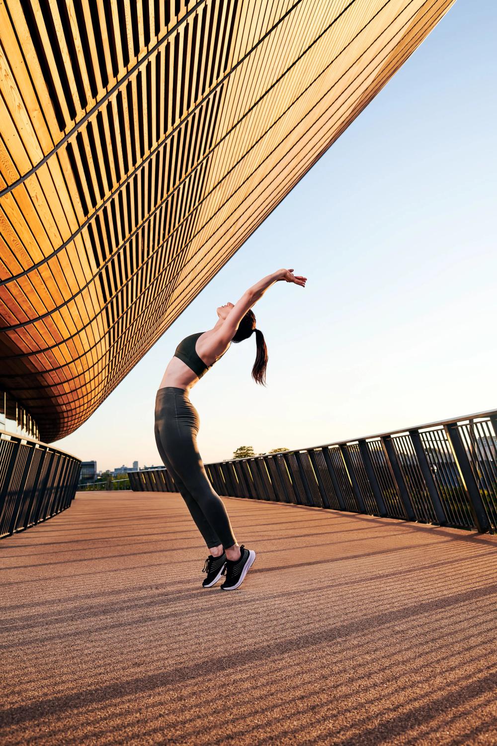 female athlete stretching in activewear at queen elizabeth olympic park london 11-RDX Sports