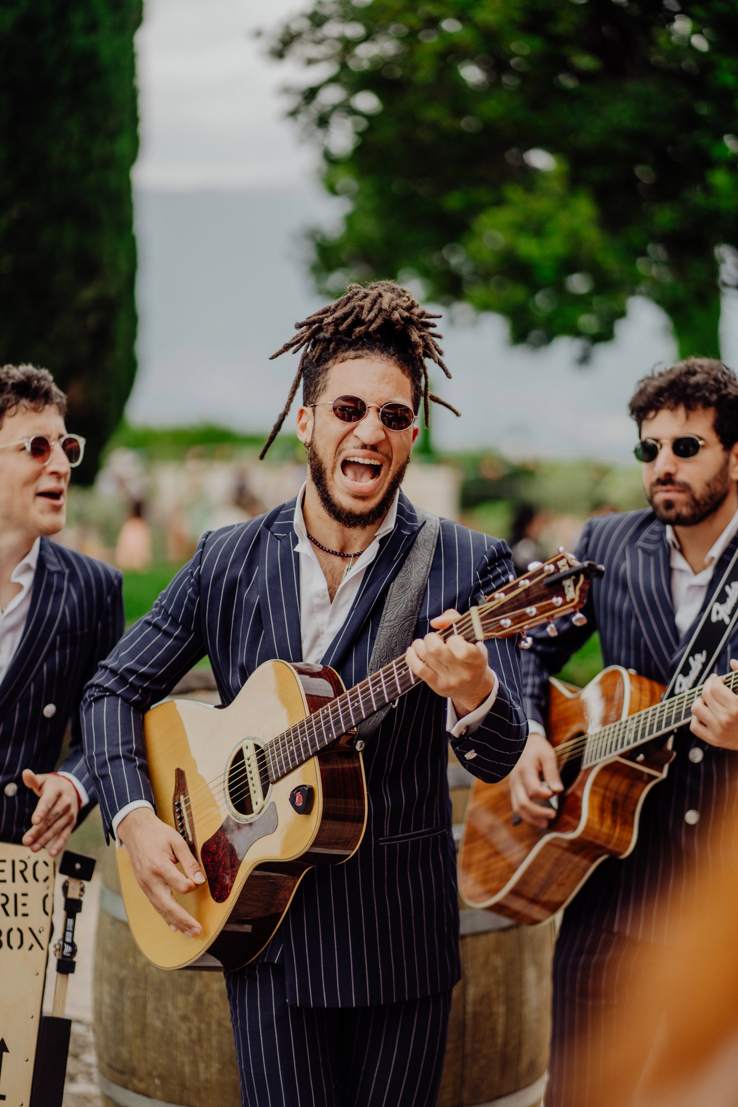 Acoustic guitarists in suits playing outdoors