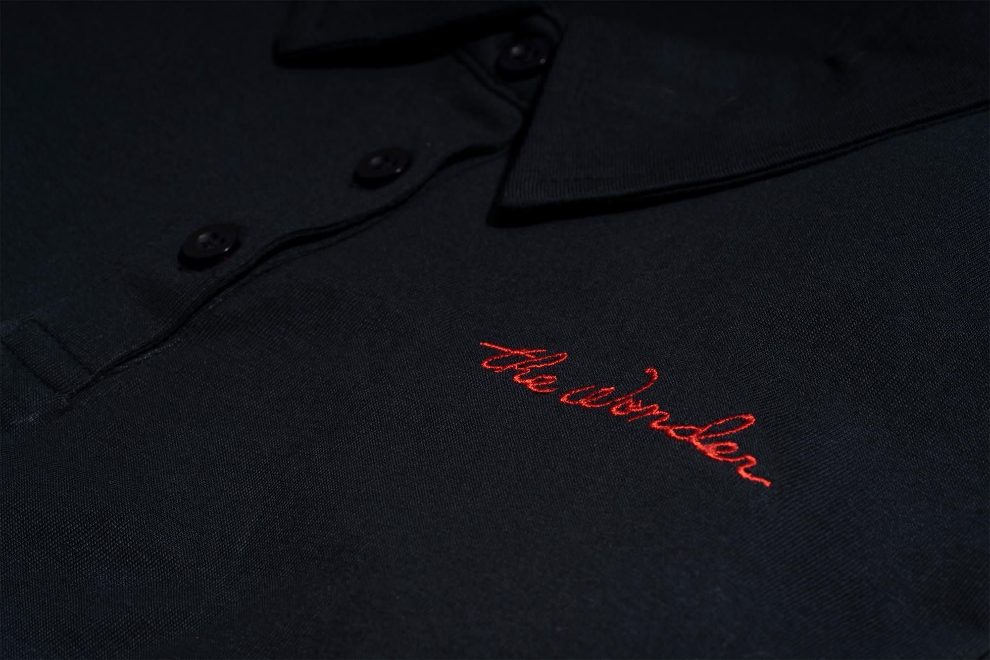 Detail of button down black shirt with logo 