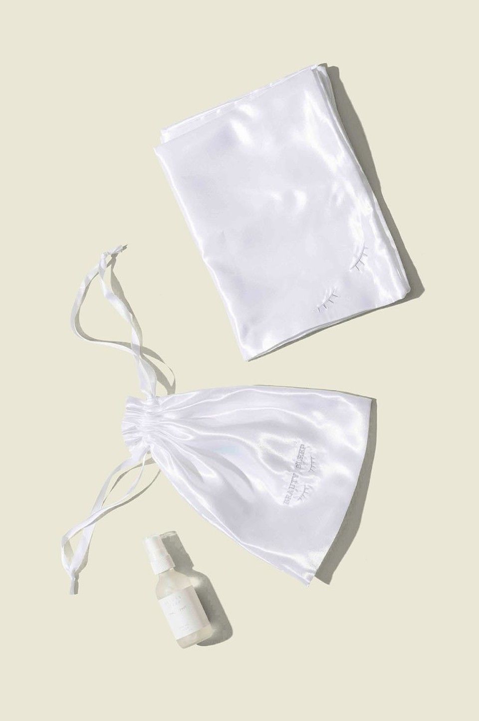 Satin drawstring pouch with bottles spray and satin cloth 