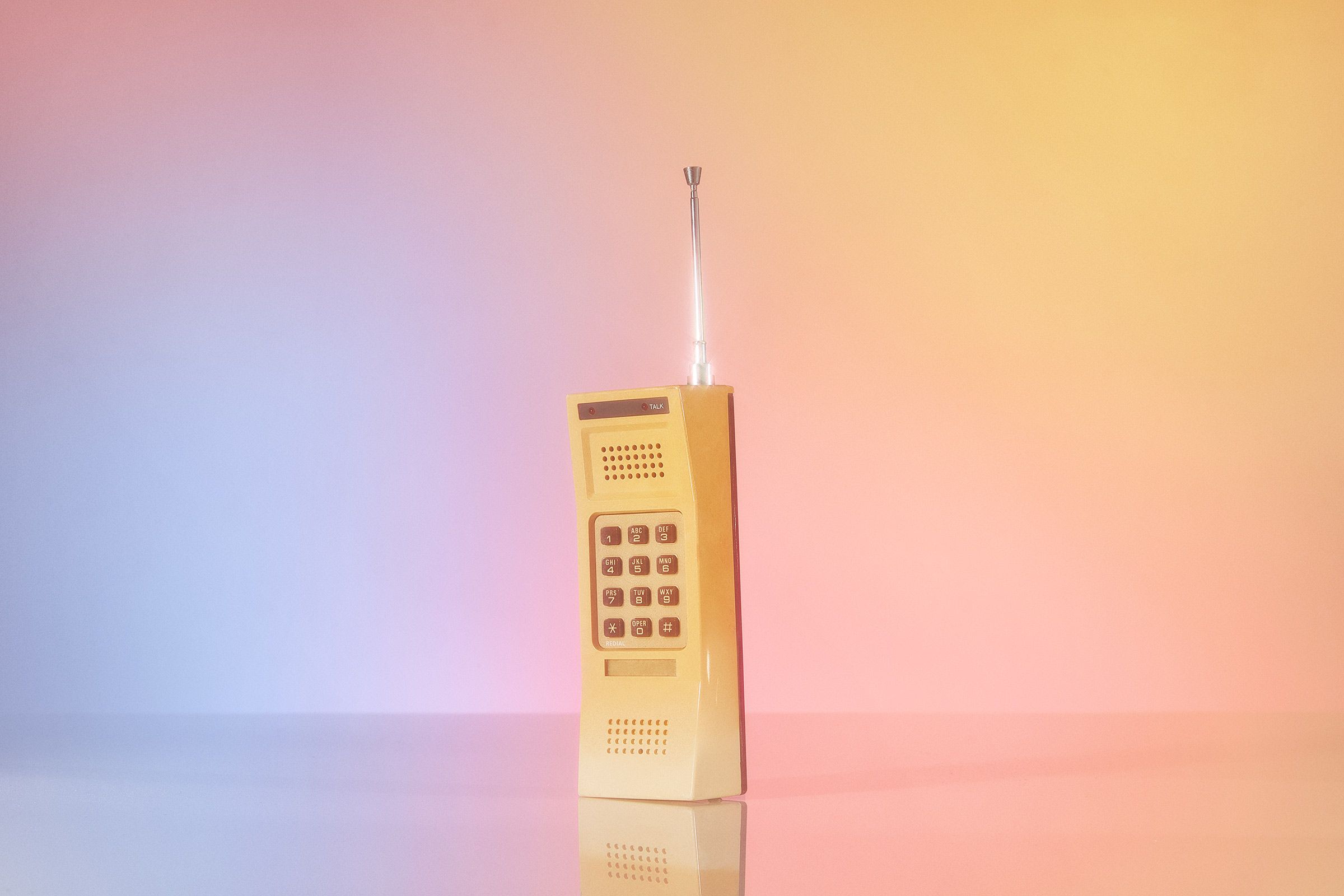 A vintage phone on a pink gradient background