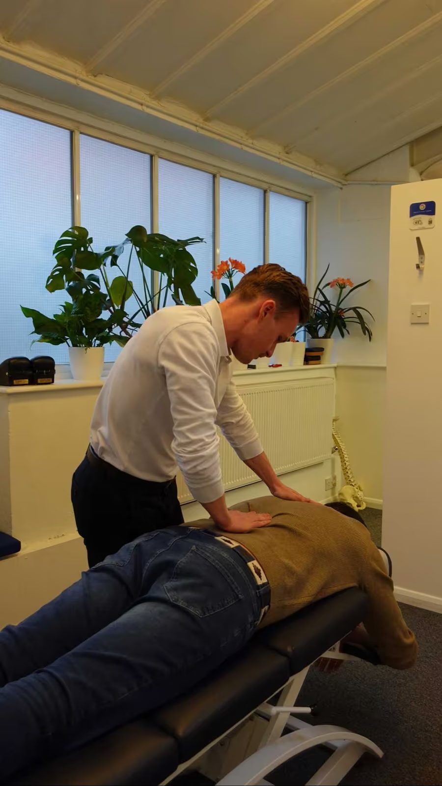 Chiropractor assessing a patient before treatment at Putney Chiropractic Centre