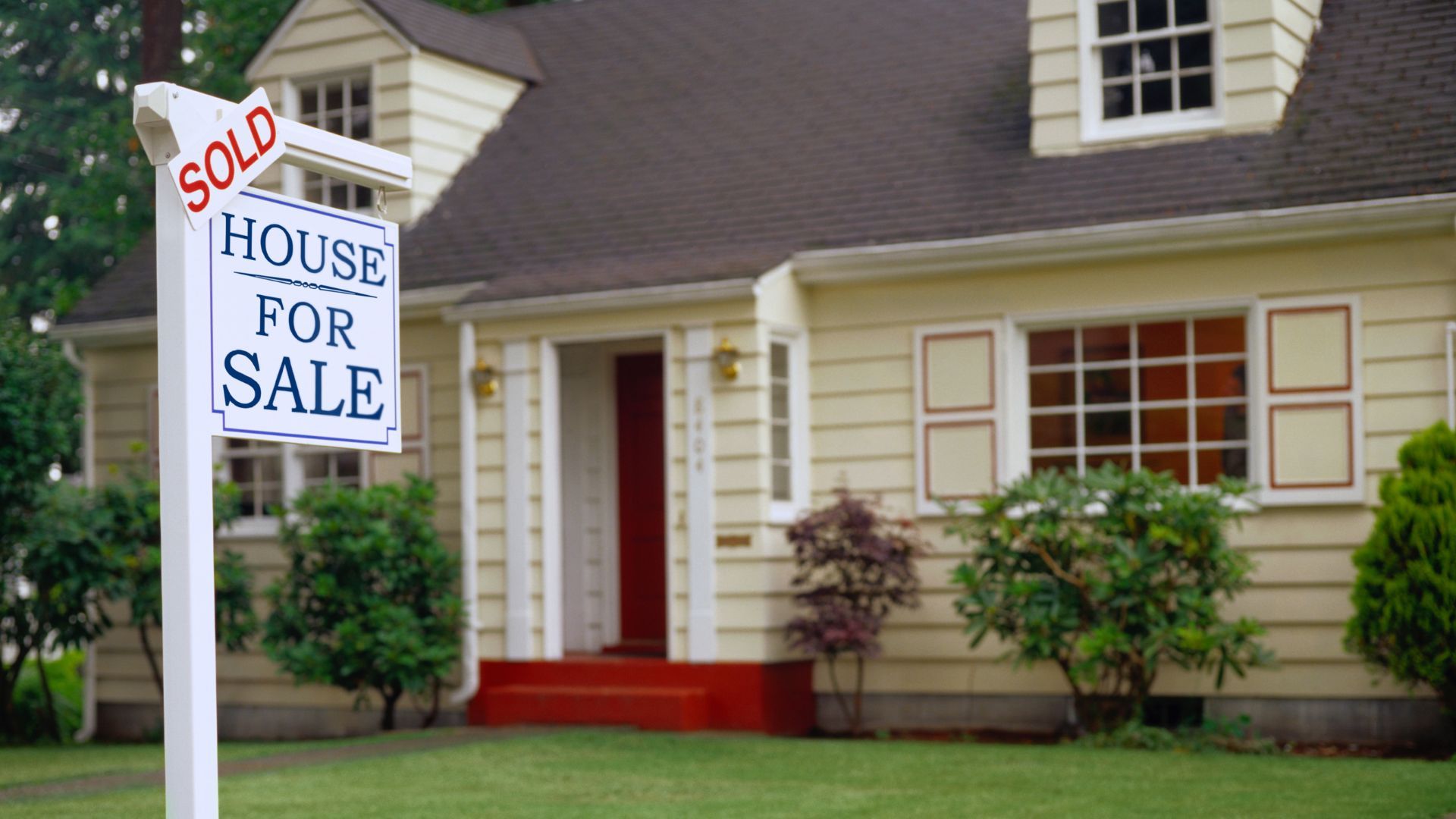 House for sale sign in front of home sold quickly as is