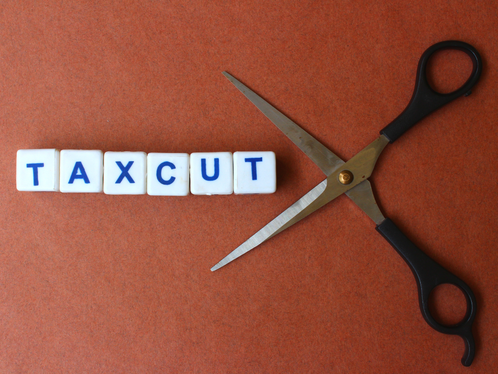 Scissors cutting the word Tax cut