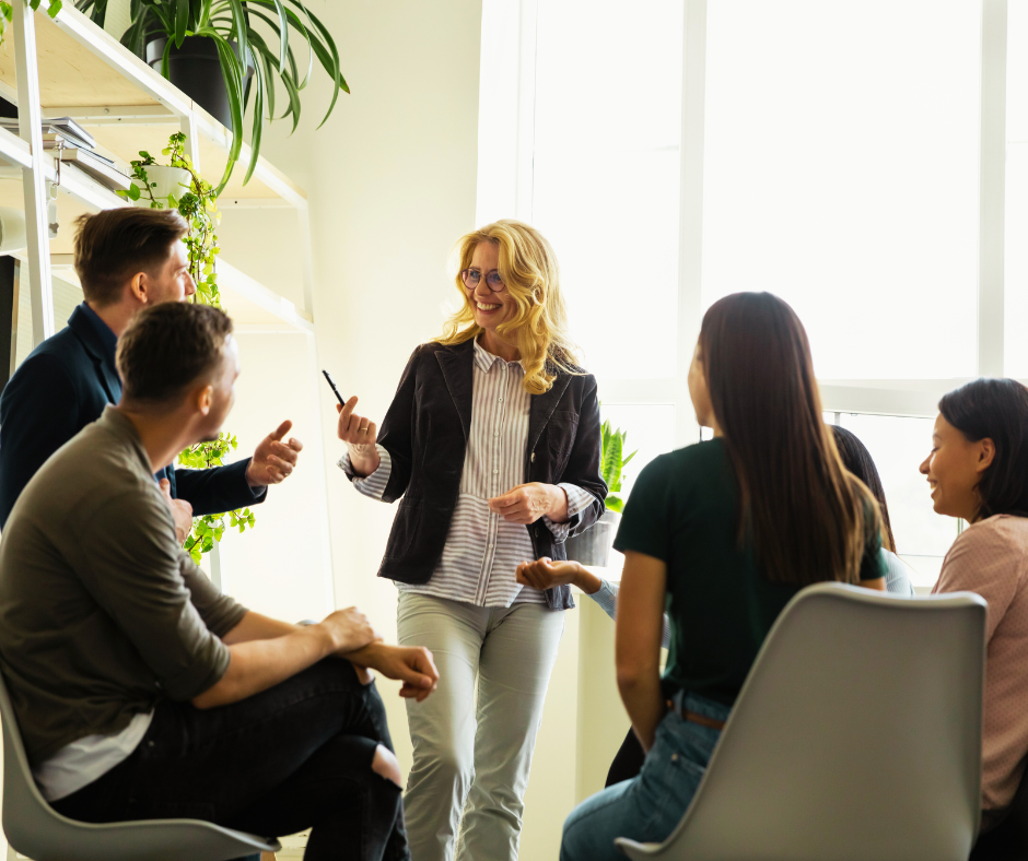 A group of people having a discussion in a workplace