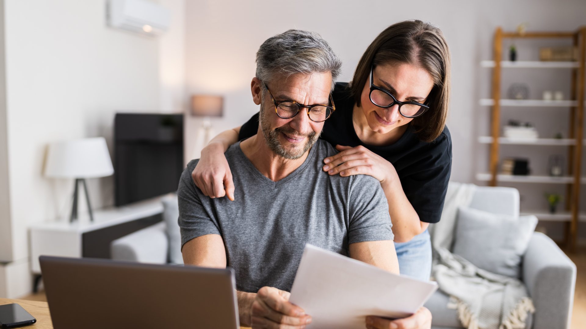 Older couple looking at computer and tax information