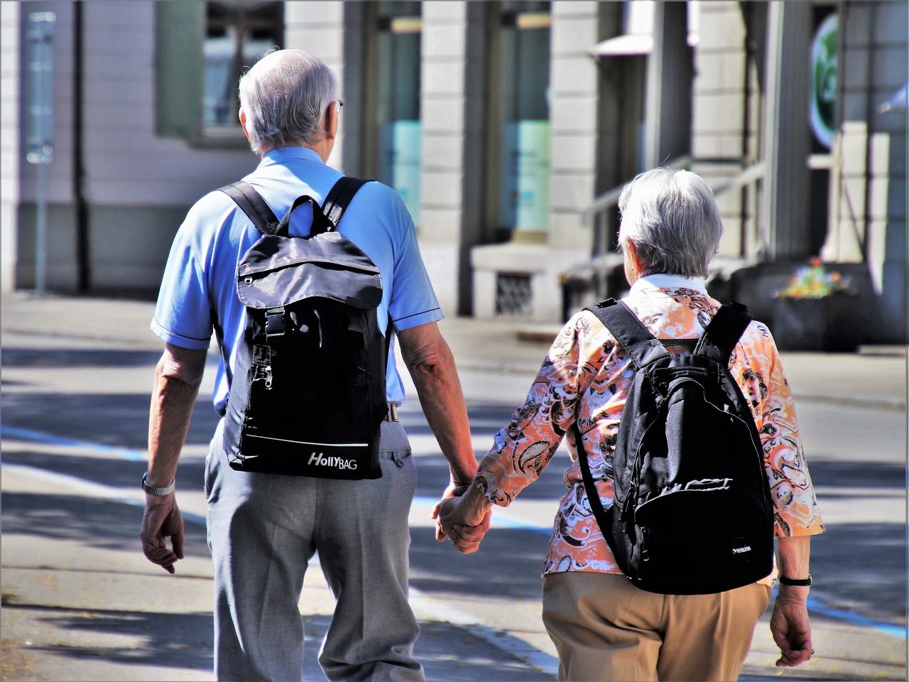 Pensioners walking hand in hand enjoyed their retirement