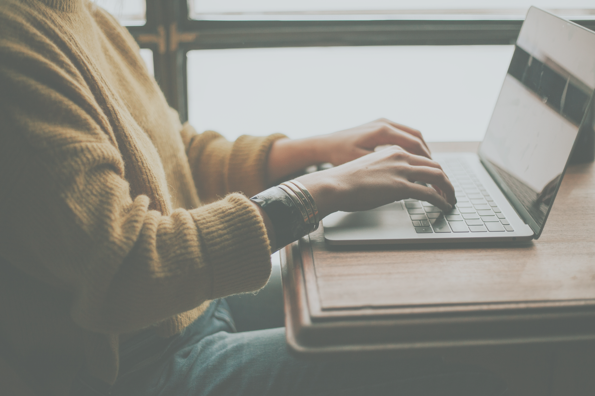 Photograph of woman working on a laptop 