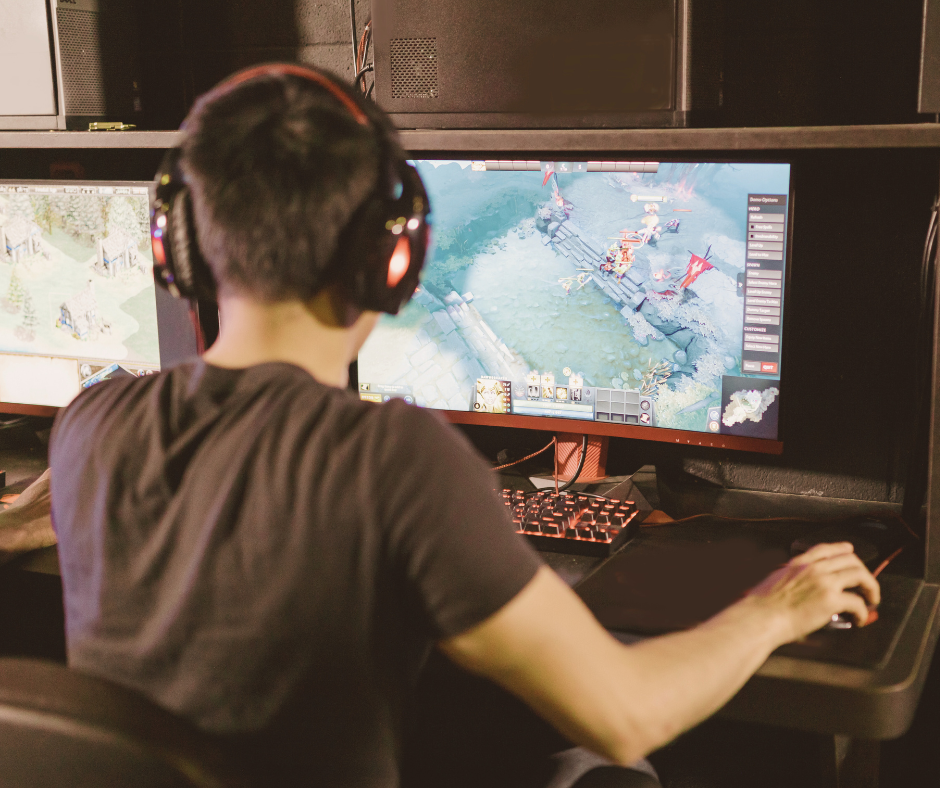 Person playing a computer game with headphones