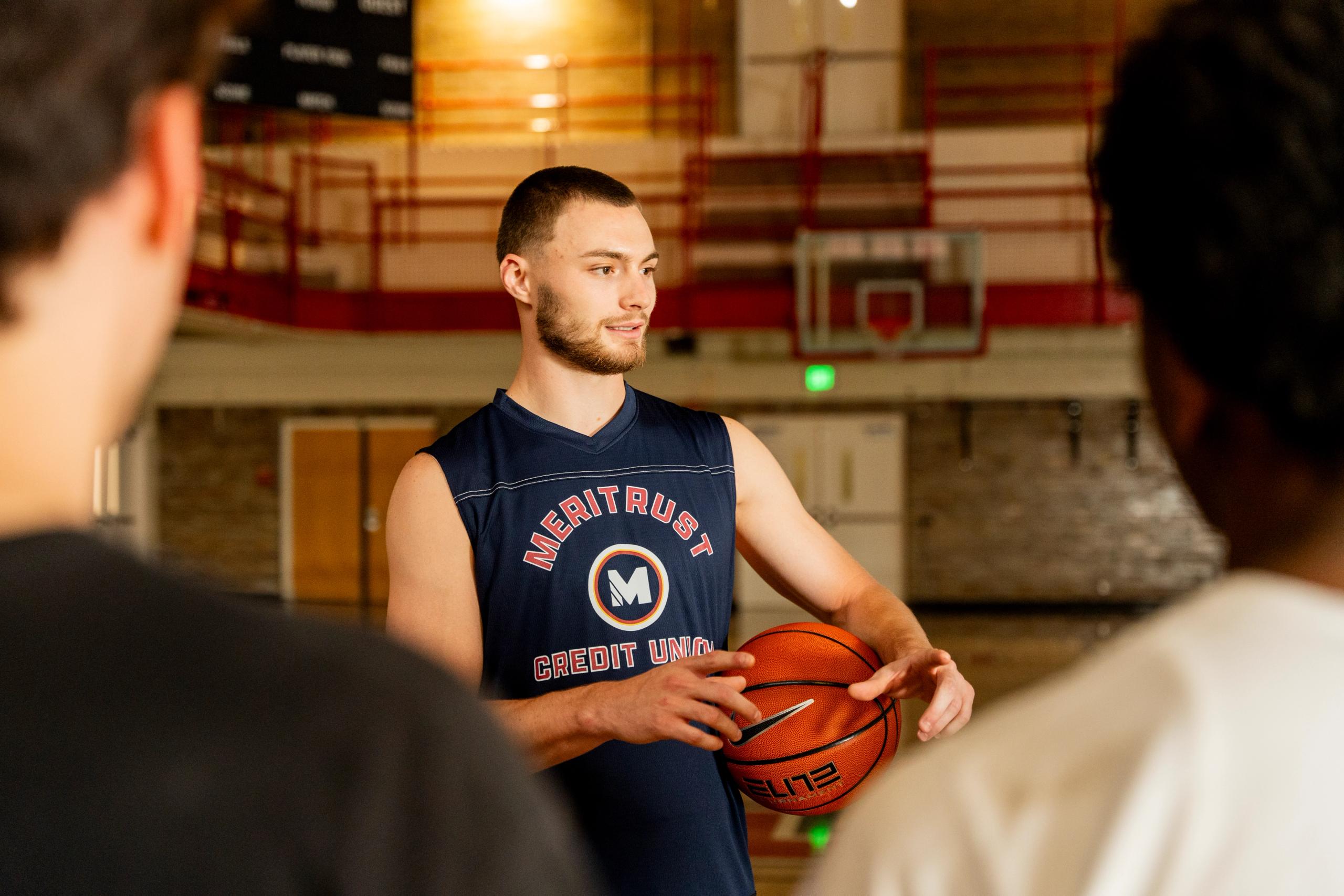 Christian Braun holding a basketball in a gym.