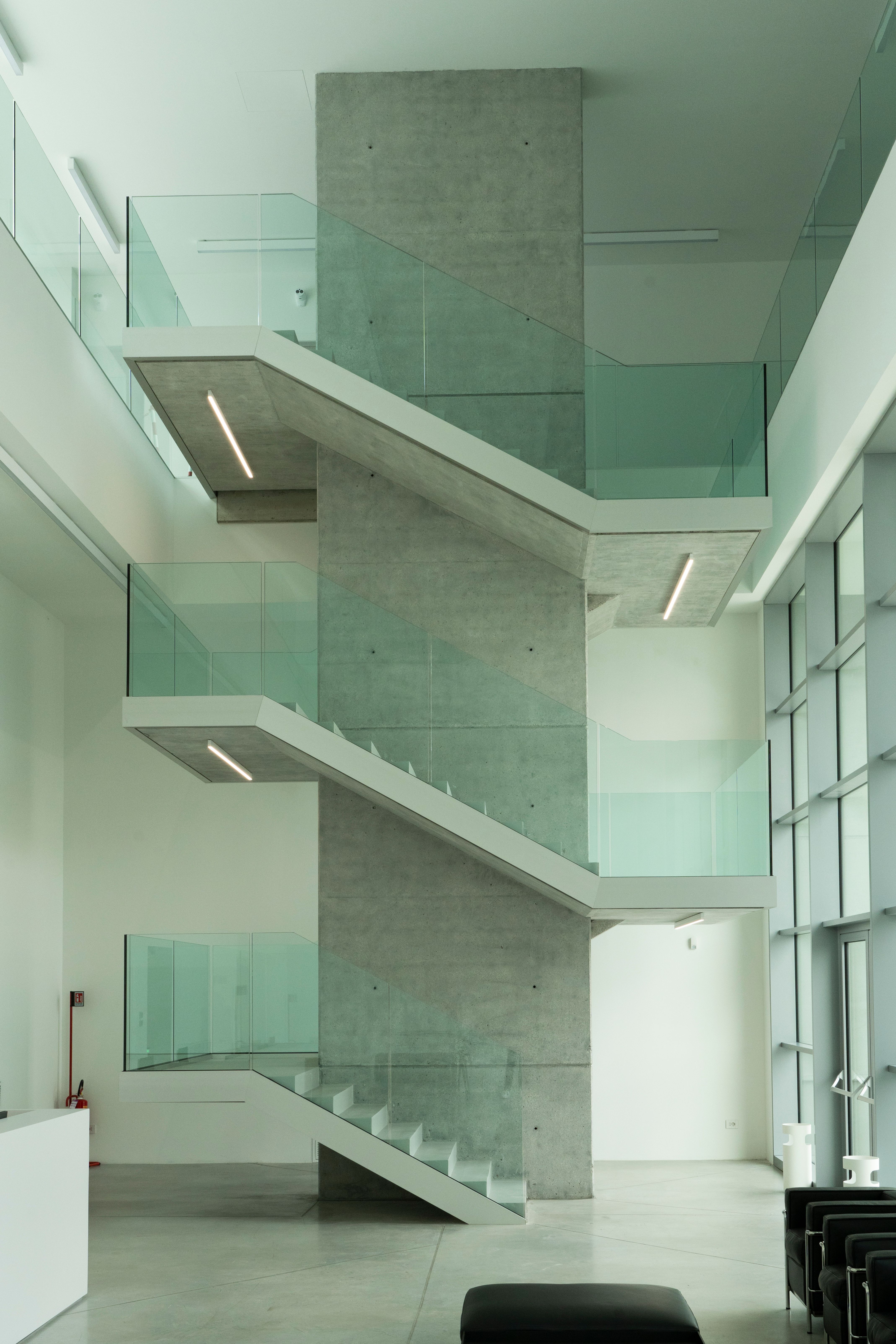 a staircase in a building with a glass railing