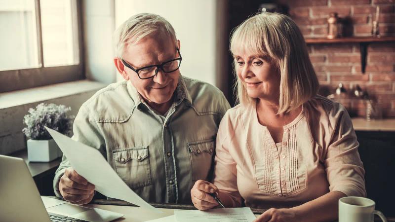 A senior couple reviewing documents together at home