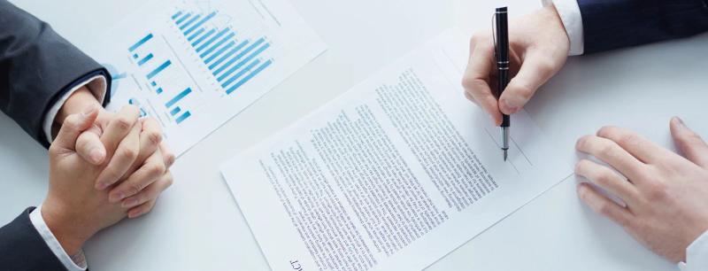 A document being signed at a table