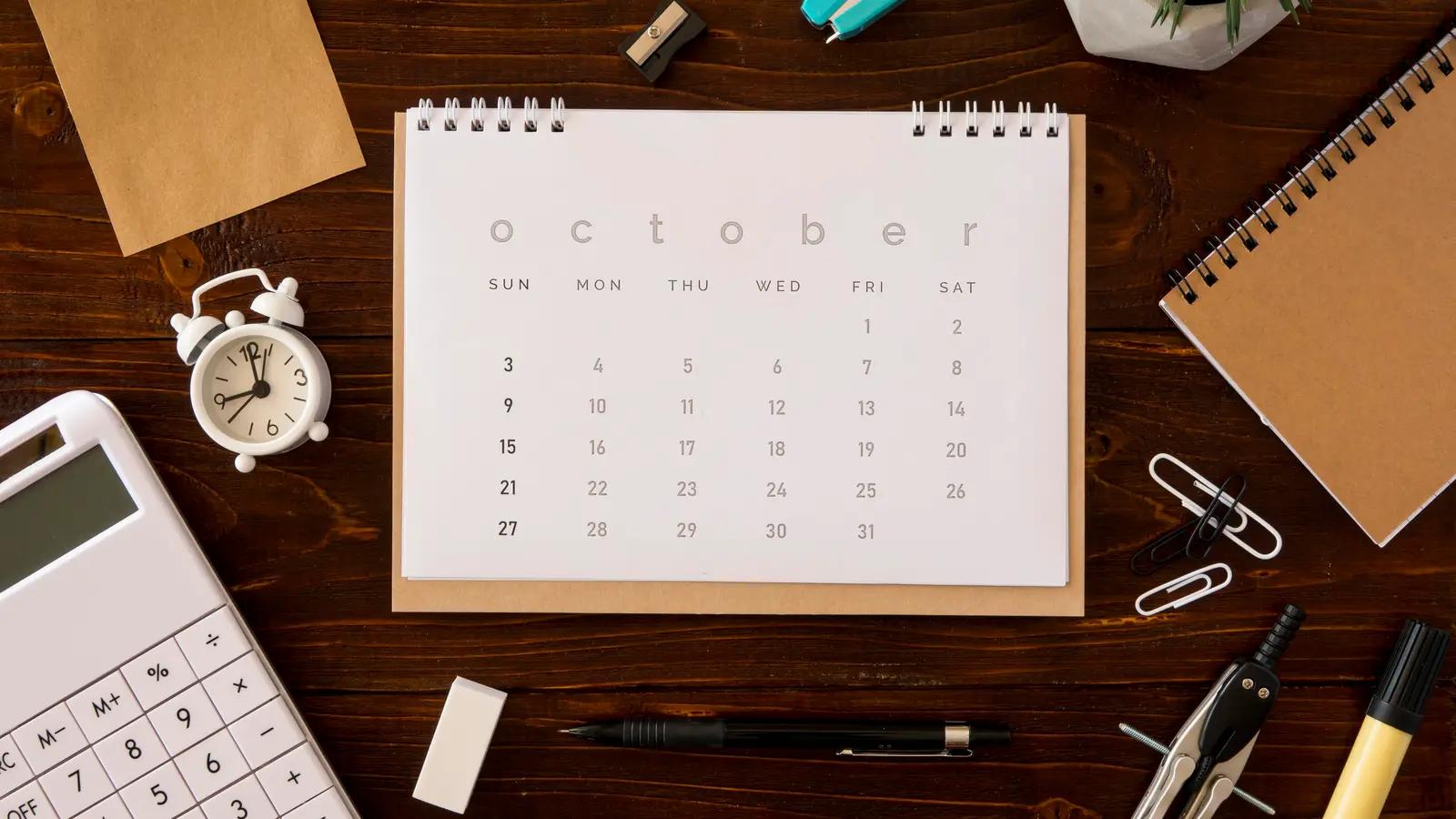 A desk calendar with a calculator and office supplies
