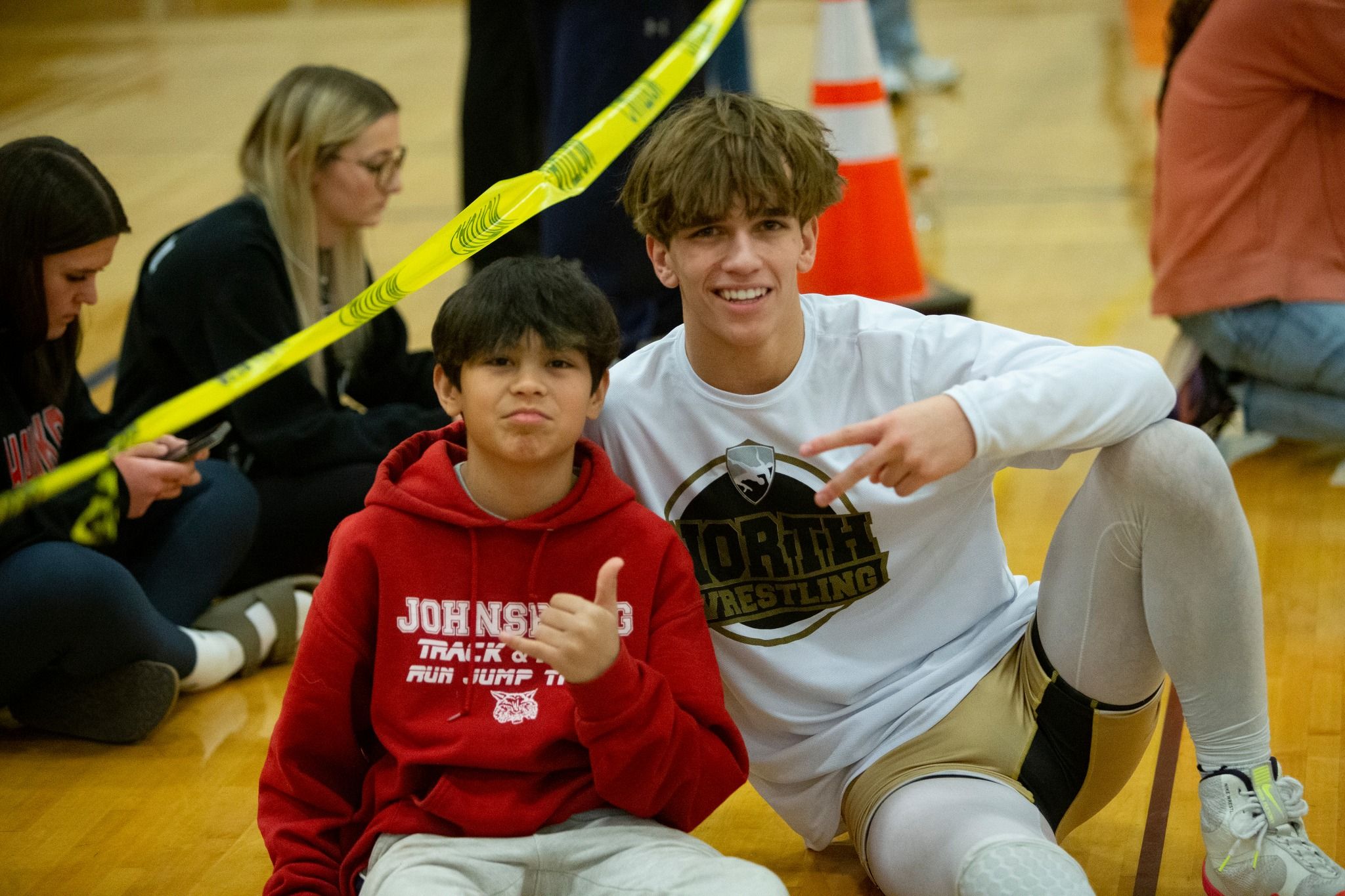 Owen with an opponent's younger brother between matches. Tom DuBois, 2024.
