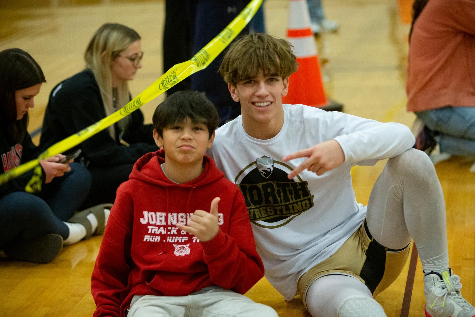Owen with an opponent's younger brother between matches. Tom DuBois, 2024.
