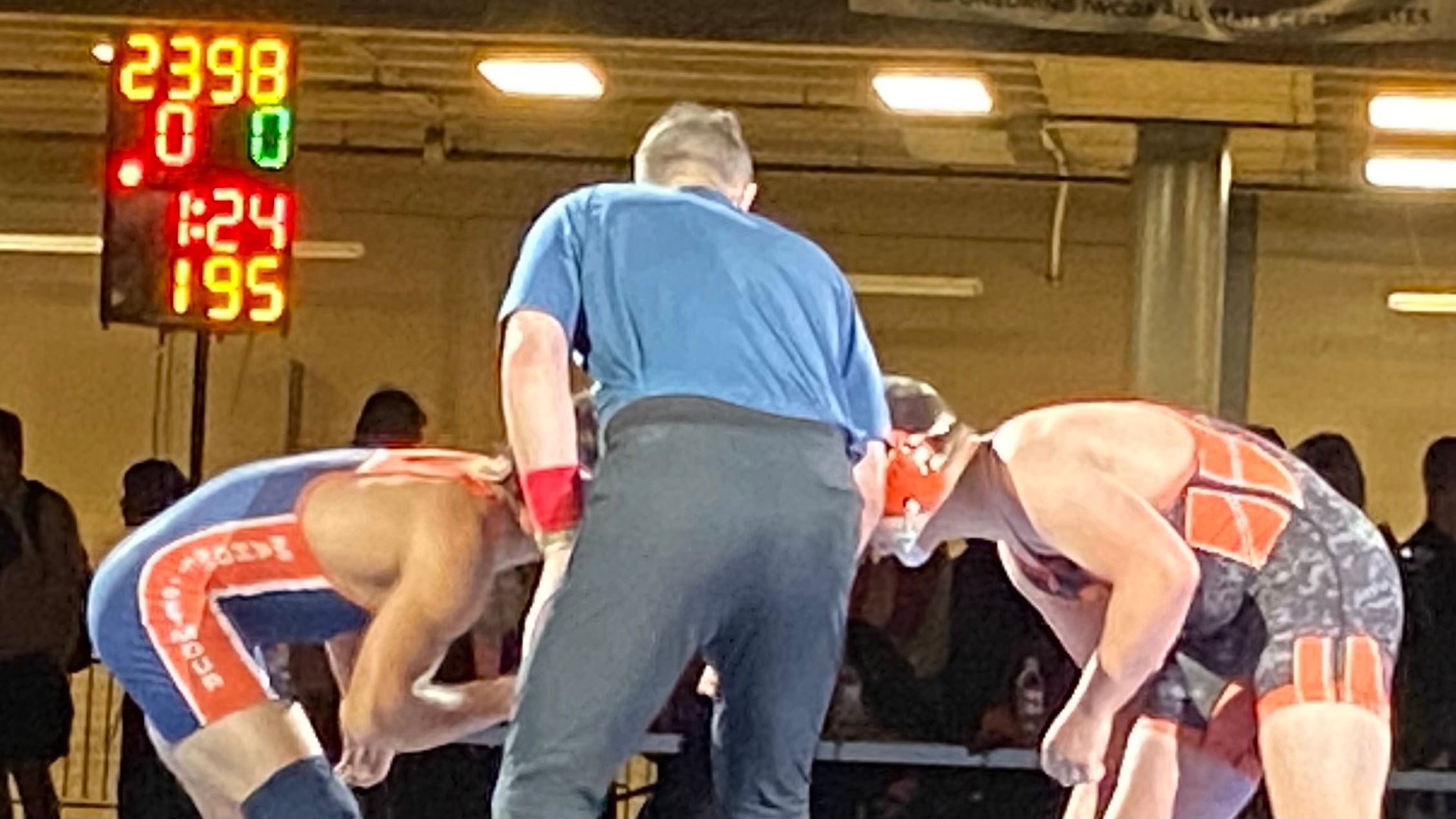 Brett Anderson on the whistle as lead official for the 195-pound finals at the IWCOA Illinois wrestling state finals, COVID-era 2021 season.