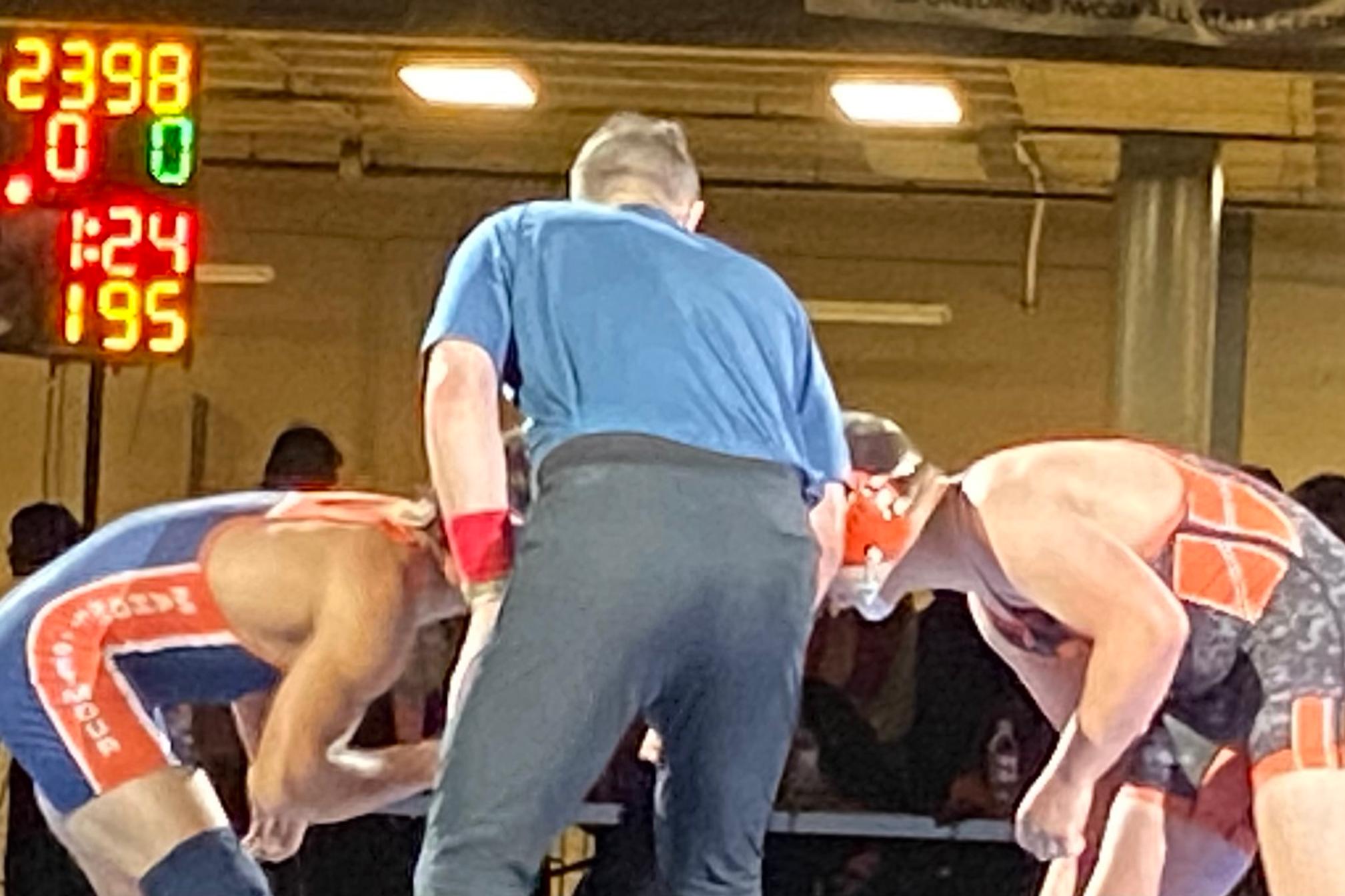 Brett Anderson on the whistle as lead official for the 195-pound finals at the IWCOA Illinois wrestling state finals, COVID-era 2021 season.