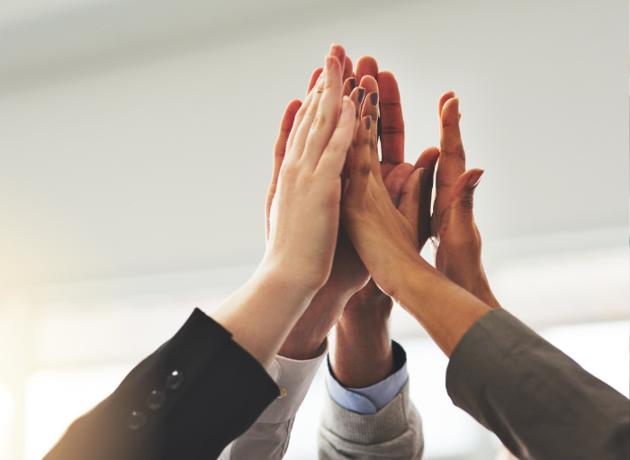group of hands in a high five