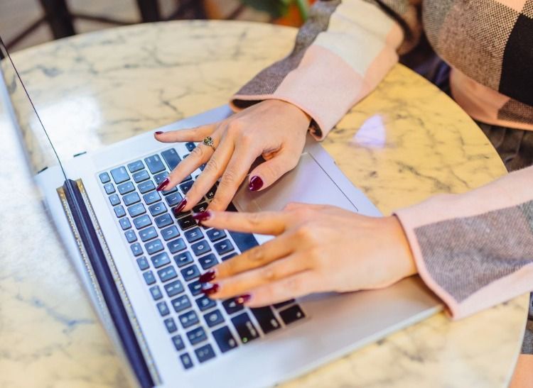 woman typing on a laptop